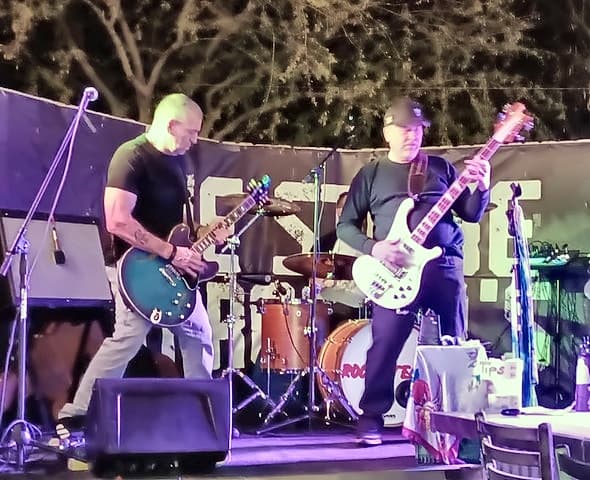 Mike on stage with his white Rickenbacker bass