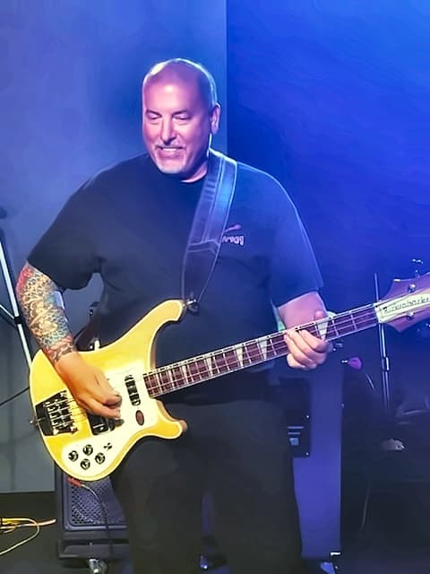 Mike Gall on stage playing his Rickenbacker bass